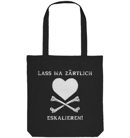Die „Krawall + Zärtlichkeit“-Poetry-Slam-Baumwolltragetasche von Artbookings/Shirtigo zeigt ein weißes Herz mit gekreuzten Knochen und den Slogan „Lass ma zärtlich eskalieren!“ – perfekt für alle, die mutige, stilvolle Statements lieben.